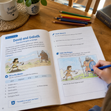 Printed workbook pages with colored pencils